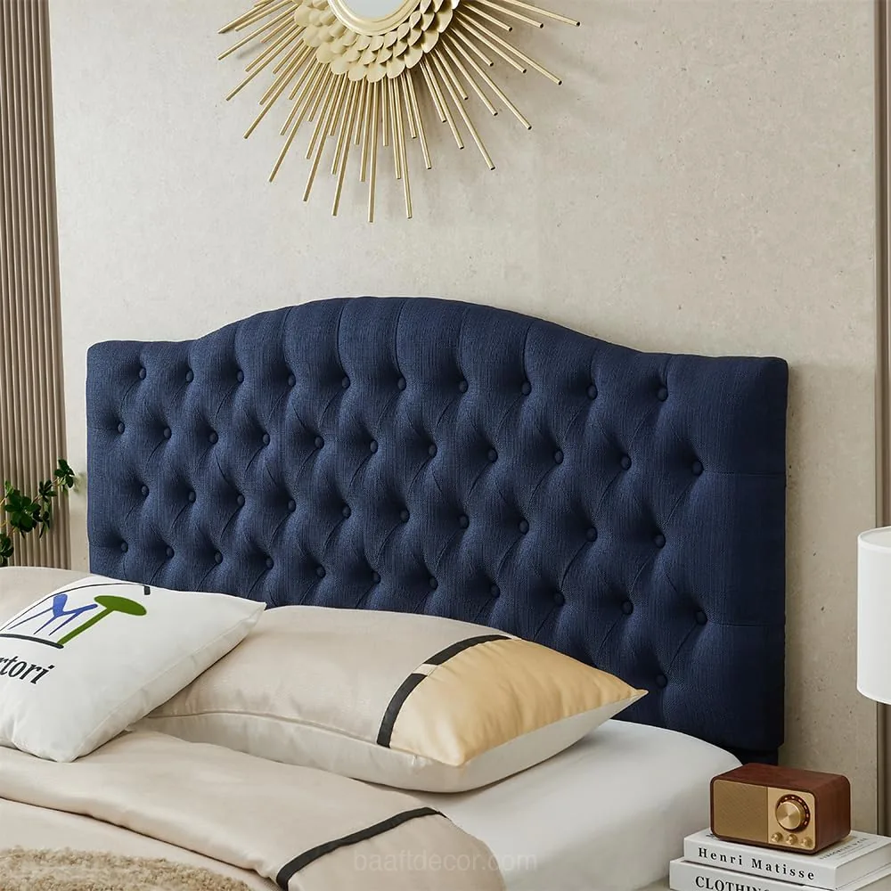 a bed with a blue headboard and pillows