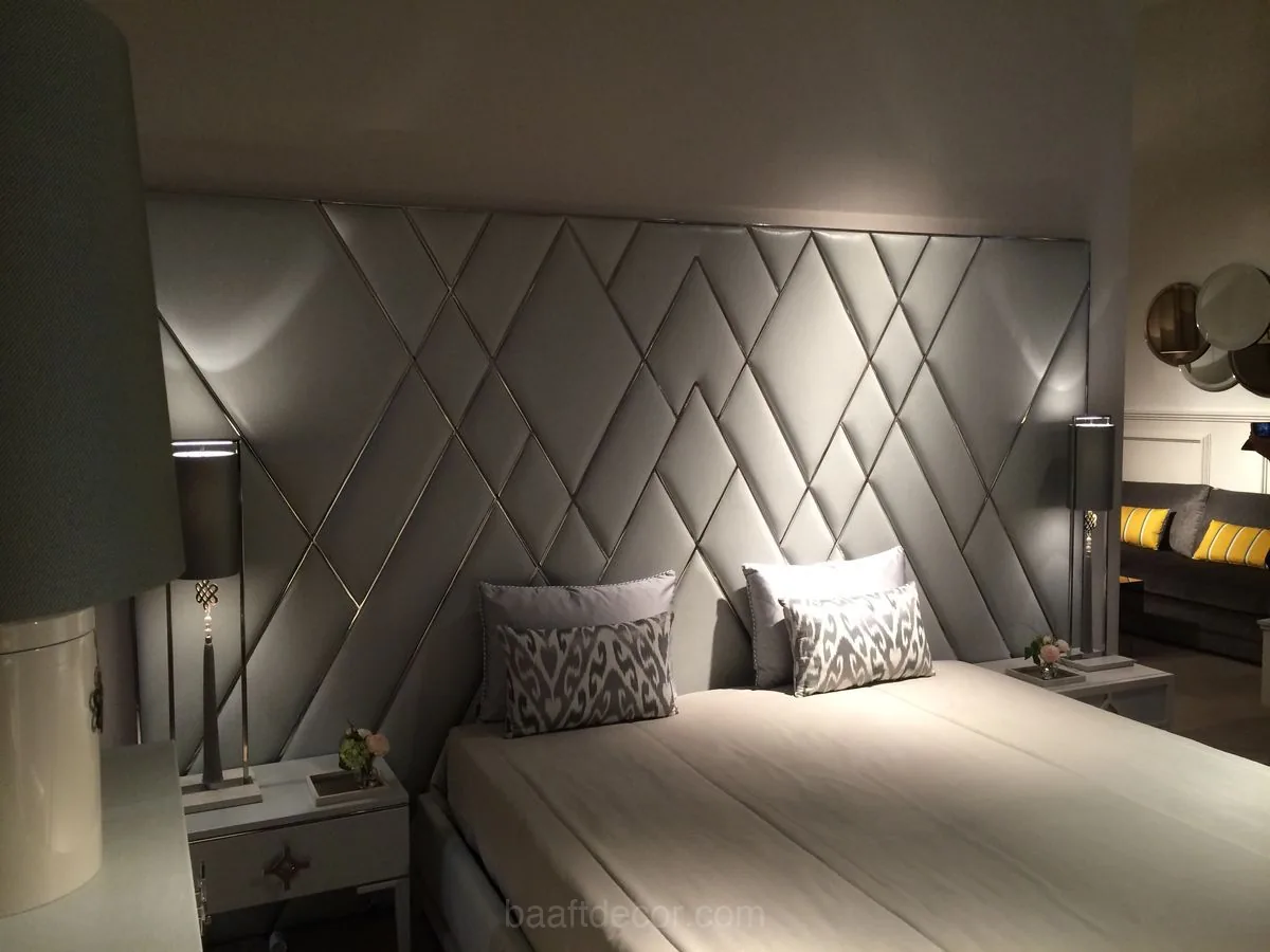 a bed with a white comforter and pillows