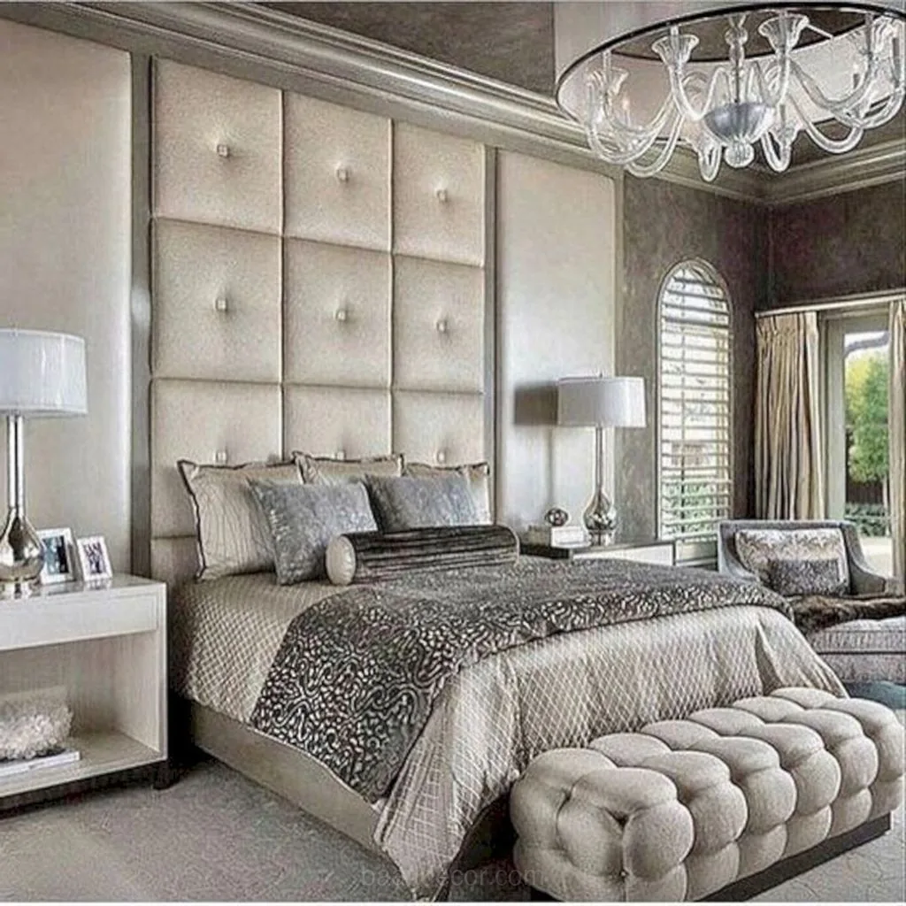 a bedroom with a large bed and a chandel