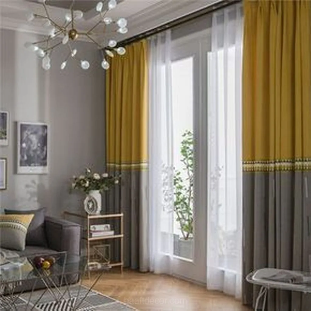 a living room with a couch, chair and a window