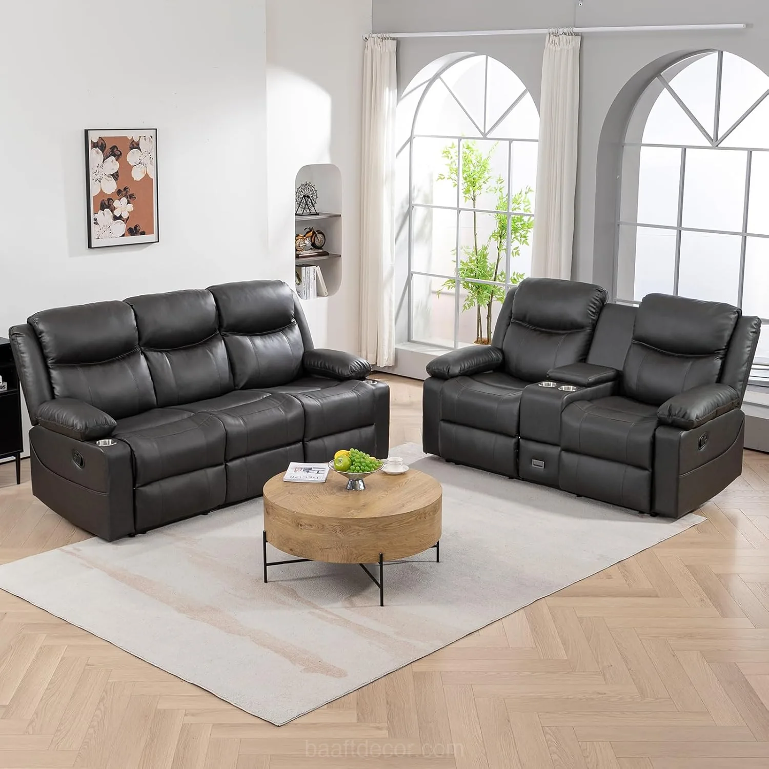 a living room with black leather sofas and a coffee table