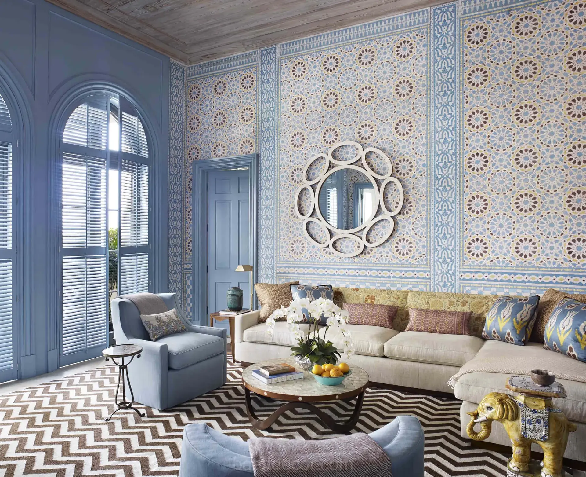 Living room with a black-and-white chevron area rug under a sectional sofa and armchairs