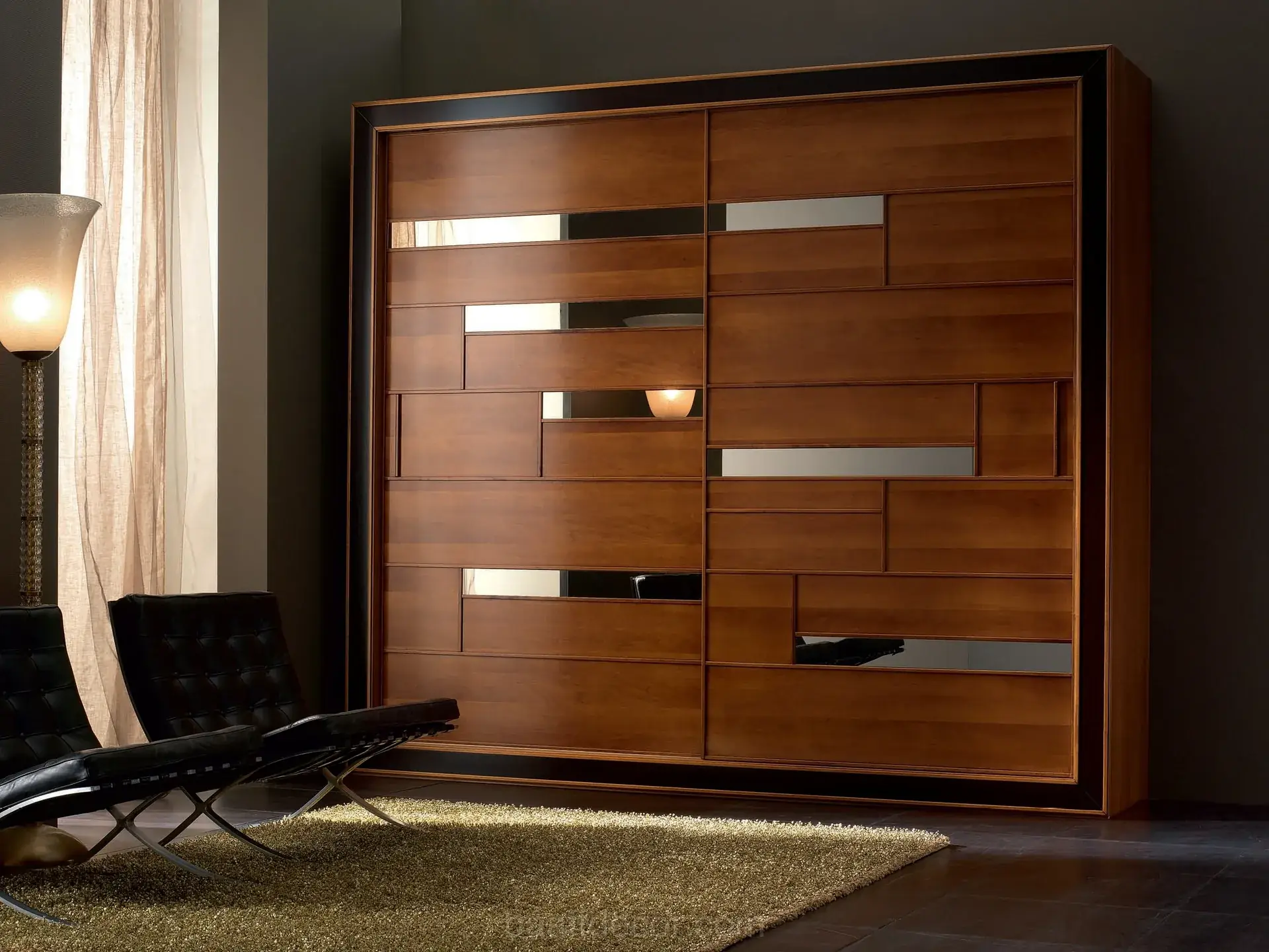 a modern living room with a black chair and a wooden door