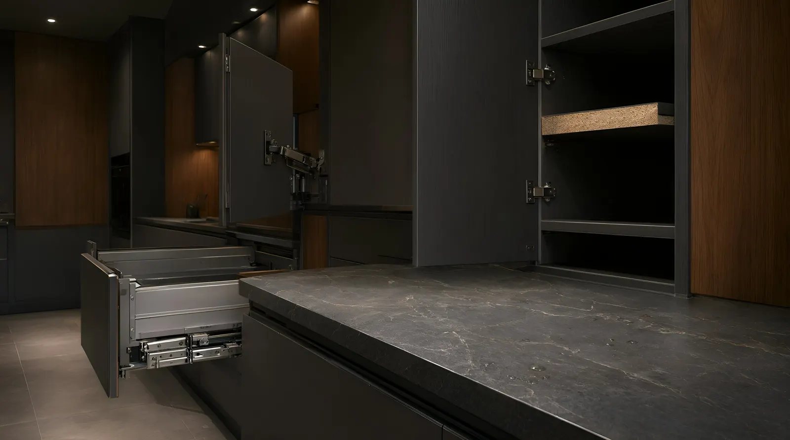 Dark fitted cabinet with its doors open on concealed hinges and a full-extension metal-sided drawer pulled out below