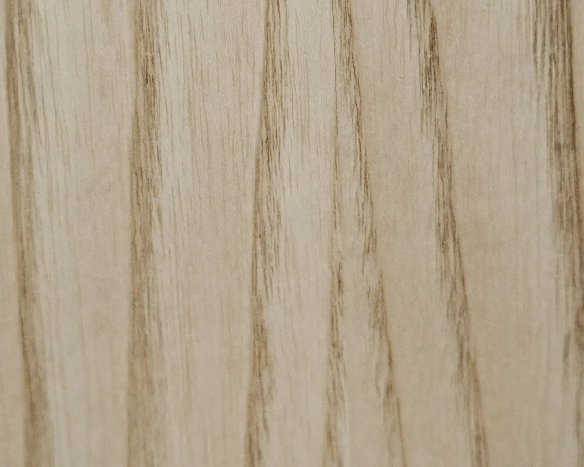 Close-up of pale natural wood with darker streaks of grain